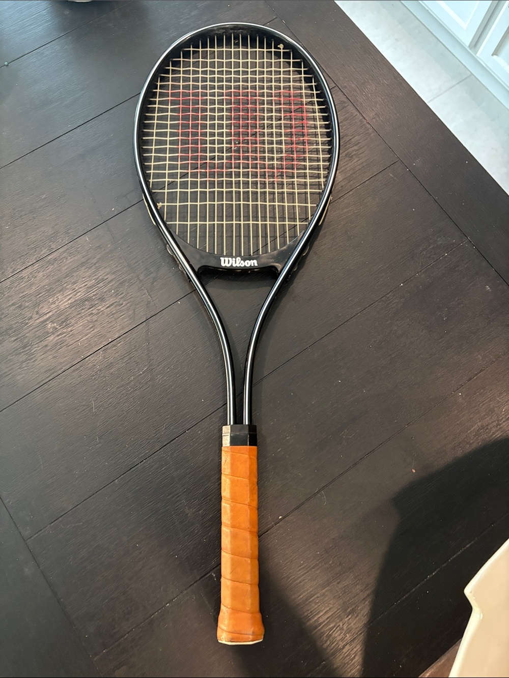 Wilson Mens/Women's Black Tennis Racket with Tan Grip and Red Logo. 4 3/8. (L3)
